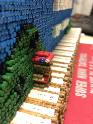 Illustration for article titled Super Mario Bros. Screenshot Recreated with 14,000 Toothpicks